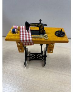 DAMAGED - Sewing Machine and Accessories on Table
